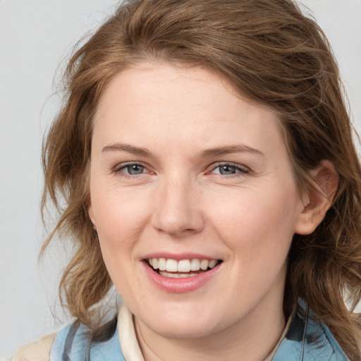 Joyful white young-adult female with medium  brown hair and blue eyes