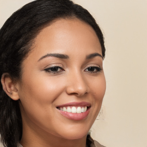 Joyful latino young-adult female with long  brown hair and brown eyes