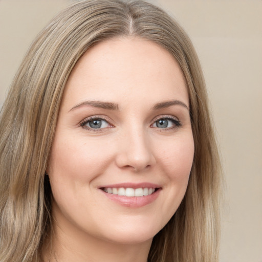 Joyful white young-adult female with long  brown hair and green eyes