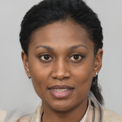 Joyful black young-adult female with short  brown hair and brown eyes