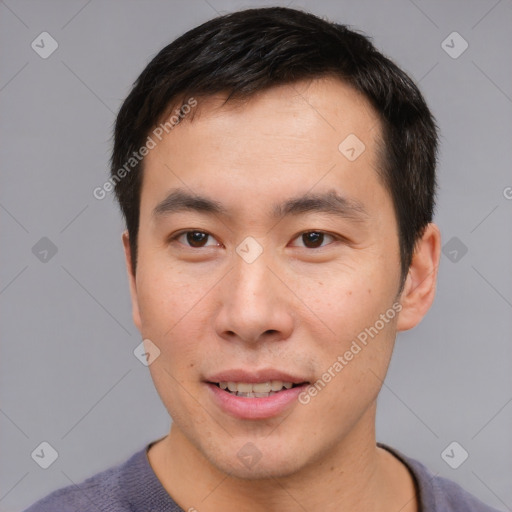 Joyful asian young-adult male with short  brown hair and brown eyes