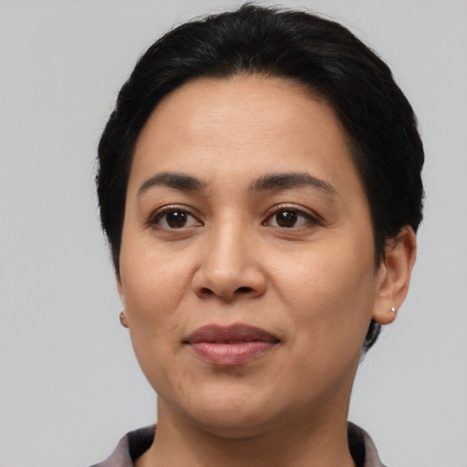 Joyful latino young-adult female with short  black hair and brown eyes