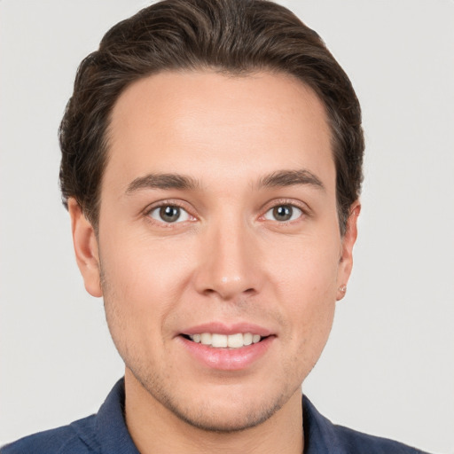 Joyful white young-adult male with short  brown hair and brown eyes