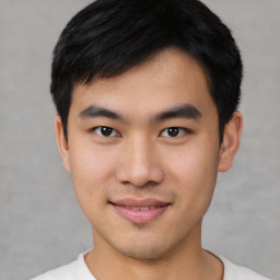 Joyful asian young-adult male with short  black hair and brown eyes