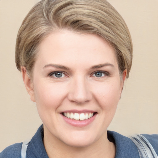 Joyful white young-adult female with short  brown hair and blue eyes