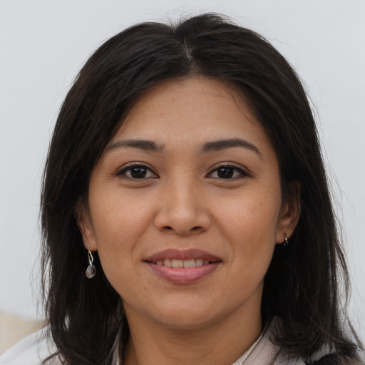 Joyful asian young-adult female with long  brown hair and brown eyes