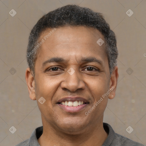 Joyful latino adult male with short  brown hair and brown eyes