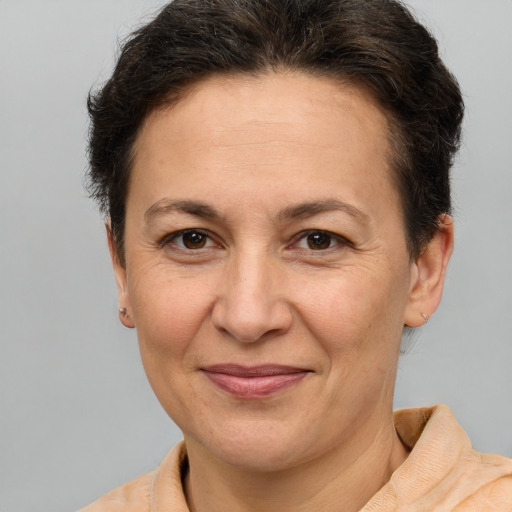 Joyful white adult female with short  brown hair and brown eyes