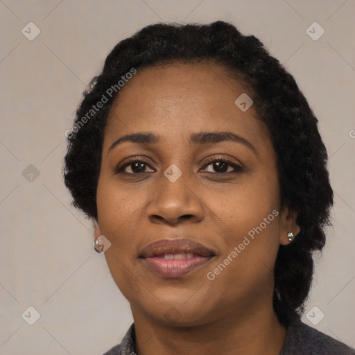 Joyful black adult female with short  black hair and brown eyes