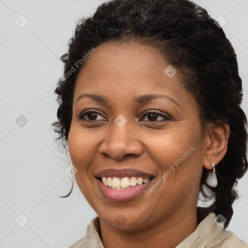 Joyful black young-adult female with medium  brown hair and brown eyes