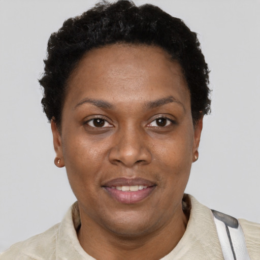 Joyful black adult female with short  brown hair and brown eyes