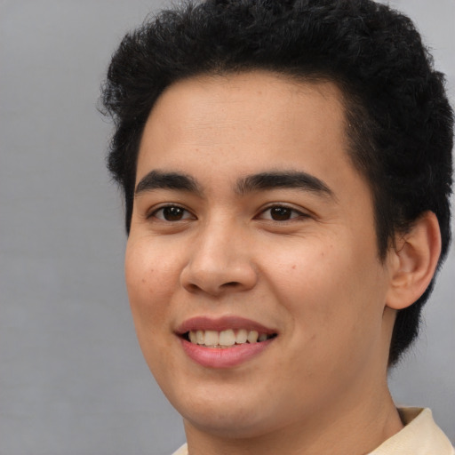Joyful latino young-adult male with short  black hair and brown eyes