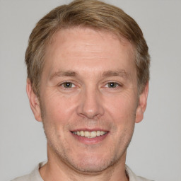 Joyful white adult male with short  brown hair and grey eyes