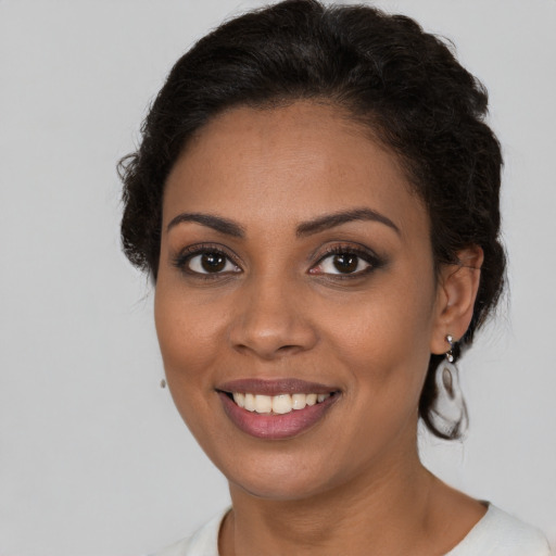Joyful black young-adult female with medium  brown hair and brown eyes