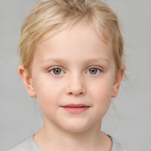 Joyful white child female with short  brown hair and blue eyes