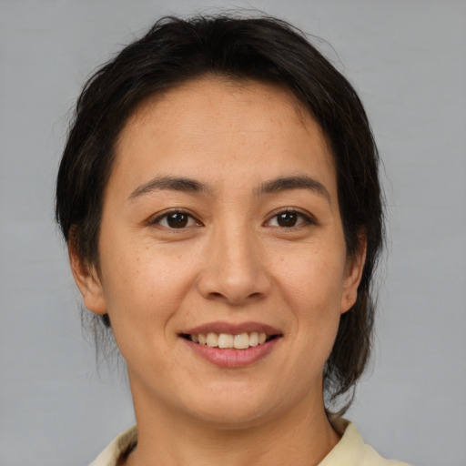 Joyful white young-adult female with medium  brown hair and brown eyes