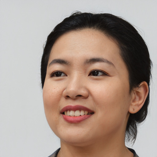 Joyful asian young-adult female with medium  black hair and brown eyes