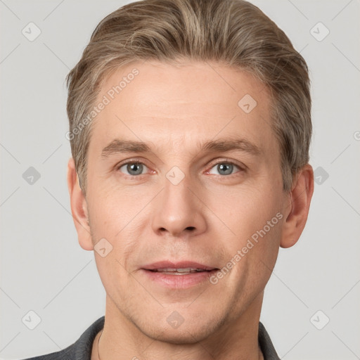 Joyful white adult male with short  brown hair and grey eyes