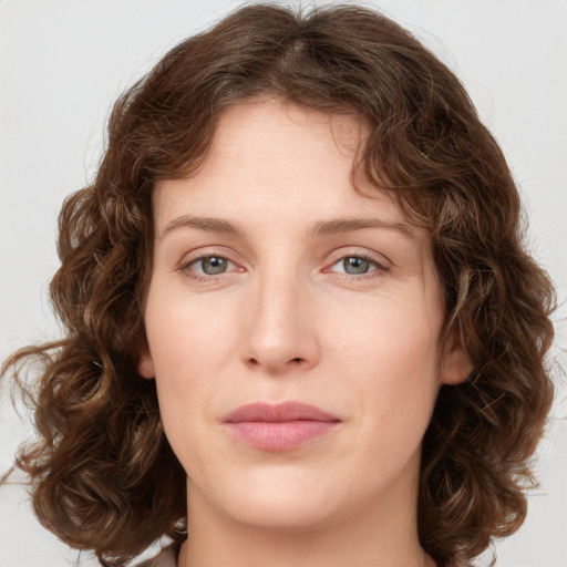 Joyful white young-adult female with medium  brown hair and green eyes