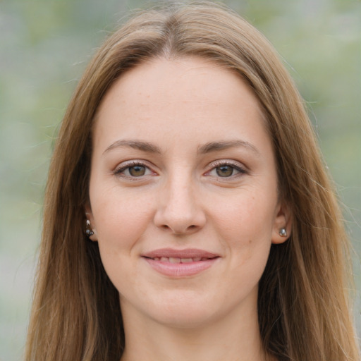 Joyful white young-adult female with long  brown hair and green eyes