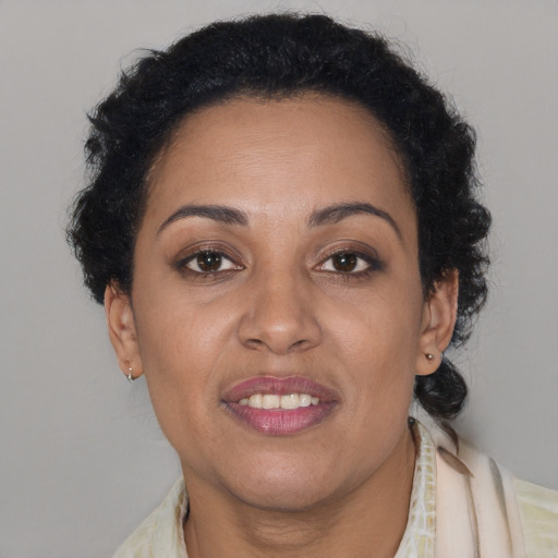 Joyful latino adult female with short  brown hair and brown eyes