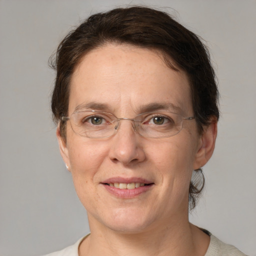 Joyful white adult female with short  brown hair and grey eyes