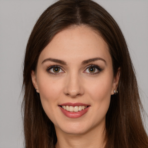 Joyful white young-adult female with long  brown hair and brown eyes