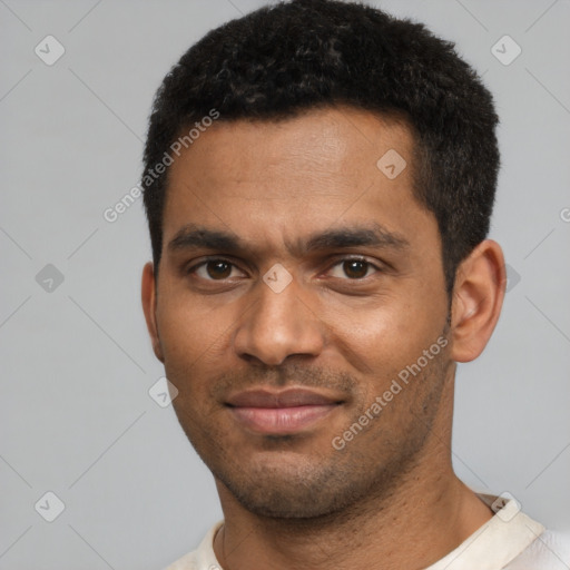 Joyful black young-adult male with short  black hair and brown eyes