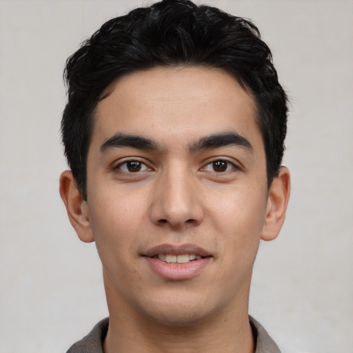 Joyful asian young-adult male with short  black hair and brown eyes