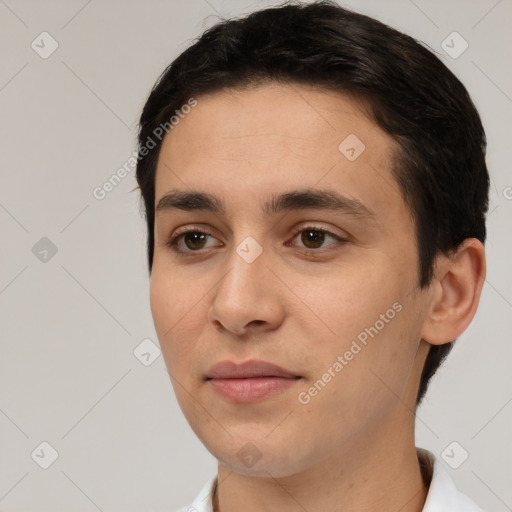 Joyful white young-adult male with short  black hair and brown eyes