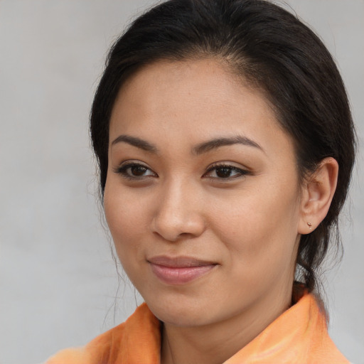 Joyful asian young-adult female with long  brown hair and brown eyes