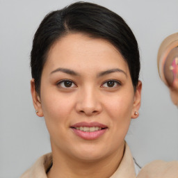 Joyful asian young-adult female with short  brown hair and brown eyes