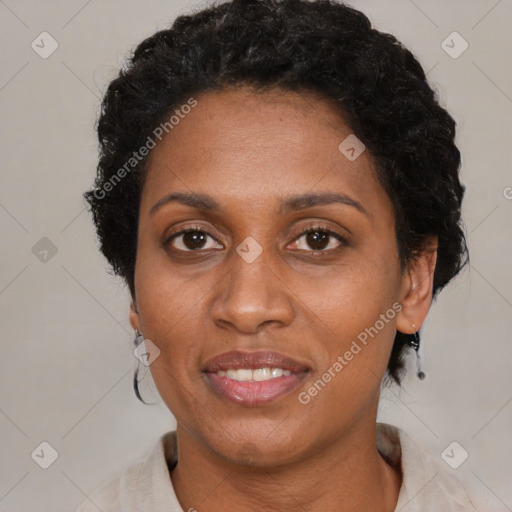 Joyful black adult female with short  black hair and brown eyes