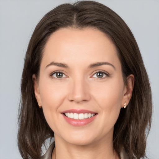 Joyful white young-adult female with medium  brown hair and brown eyes