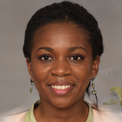 Joyful black young-adult female with short  black hair and brown eyes