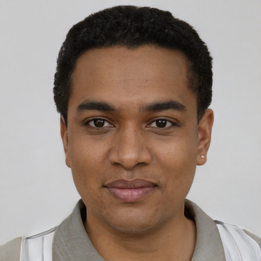 Joyful black young-adult male with short  black hair and brown eyes