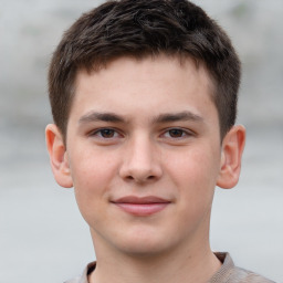 Joyful white child male with short  brown hair and brown eyes