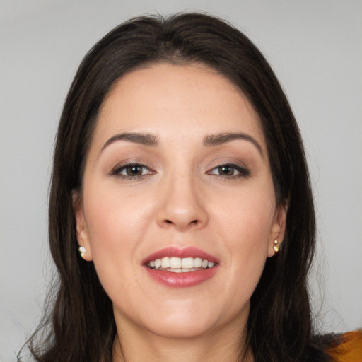 Joyful white young-adult female with long  brown hair and brown eyes