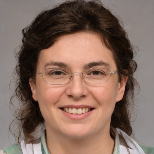 Joyful white adult female with medium  brown hair and blue eyes