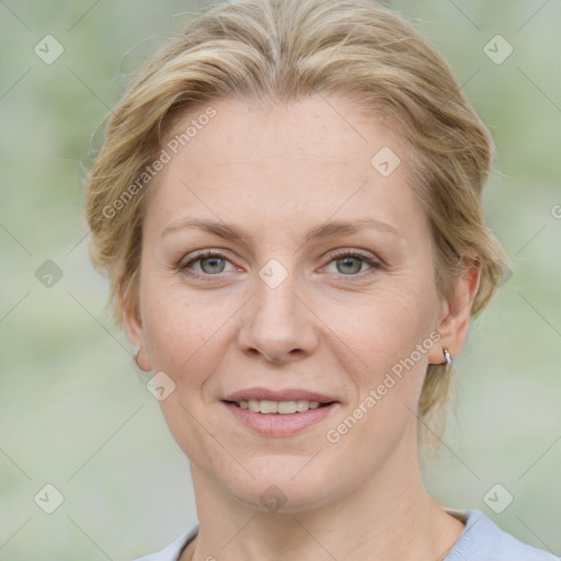 Joyful white adult female with medium  brown hair and blue eyes