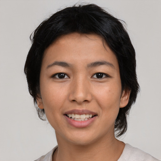 Joyful asian young-adult female with medium  black hair and brown eyes
