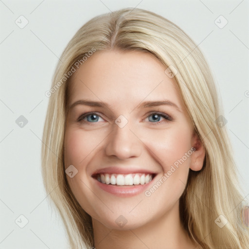 Joyful white young-adult female with long  brown hair and blue eyes