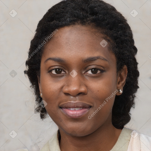 Joyful black young-adult female with long  black hair and brown eyes