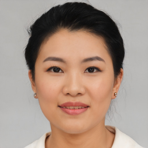 Joyful asian young-adult female with medium  black hair and brown eyes