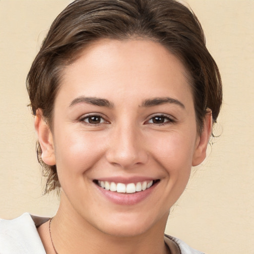 Joyful white young-adult female with medium  brown hair and brown eyes