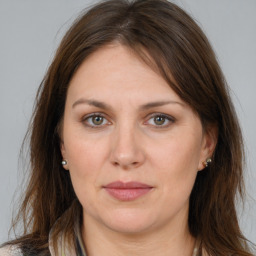 Joyful white adult female with long  brown hair and brown eyes