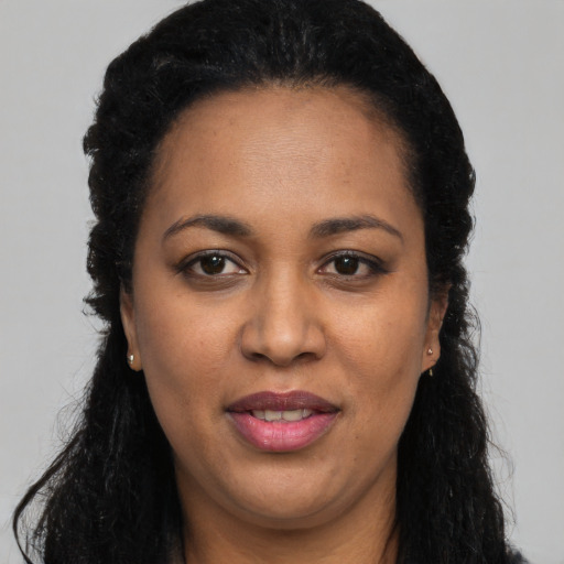 Joyful latino adult female with long  black hair and brown eyes