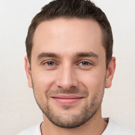 Joyful white young-adult male with short  brown hair and brown eyes