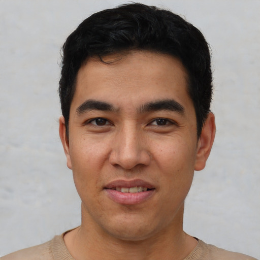 Joyful asian young-adult male with short  black hair and brown eyes