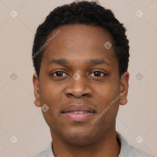 Joyful black young-adult male with short  brown hair and brown eyes